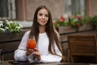 Young beautiful woman in a cafe holding