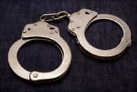 handcuffs with a key on jeans background