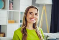 A young blonde-haired woman smiles in a