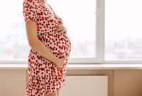 Closeup of a pregnant woman wearing a