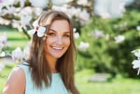 beautiful woman in blossom park smiling