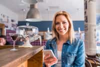Blond woman in denim shirt sitting at