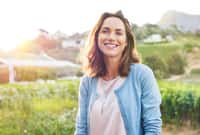 Cheerful mature woman enjoying in park during