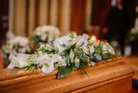 A coffin decorated with many flowers and