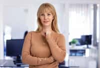 Attractive blond haired woman wearing turtleneck sweater