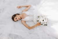 Beautiful bride with wedding bouquet of flowers,