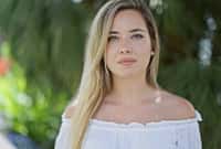 Young blonde woman standing with serious expression