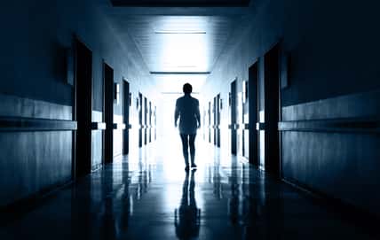 Woman walking on the dark corridor