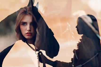 Woman silhouette with her horse at outdoors ranch