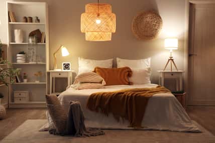 Cozy bedroom at night with a light on.
