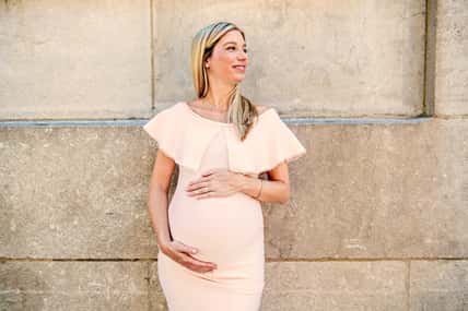 A Portrait of a pregnant woman in city street