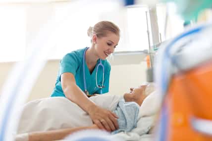 Senior patient and nurse in hospital