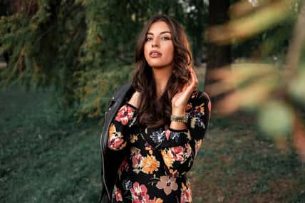 Fall fashiom and beauty portrait, attractive feminine brunette in dress and with leather jacket