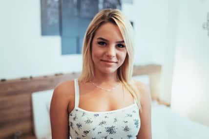 Portrait of a beautiful blonde in bedroom