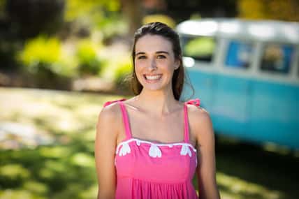 Smiling woman standing in park