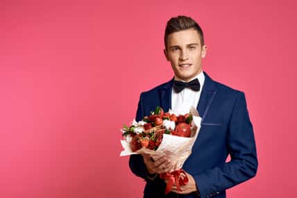 elegant gentleman with a bouquet of flowers and fruits