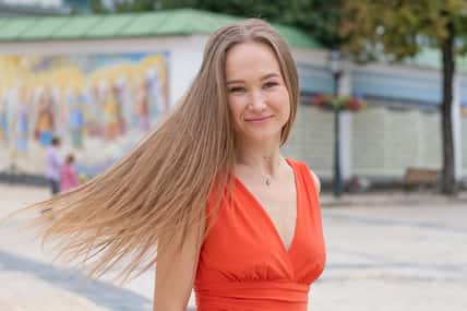 Attractive, Slim, Beautiful Girl Wearing White Shirt And Maxi Long Red Silk Fabric Skirt Fly And Wave In The Wind Walking. Fashion Concept
