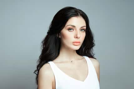 fashion woman with long hair, curly strong hair of a brunette girl. Natural cosmetics for hair care, strong roots
