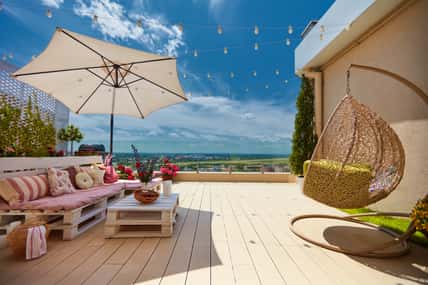 a cozy rooftop patio with wooden pallet