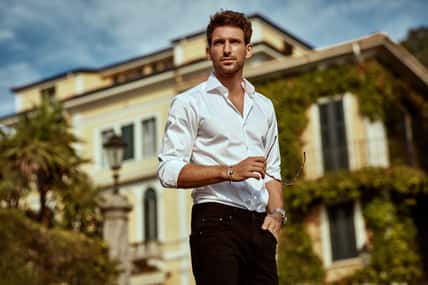 Handsome young man in front of luxury home villa