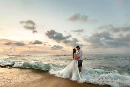 Bride and groom hugging on the beach