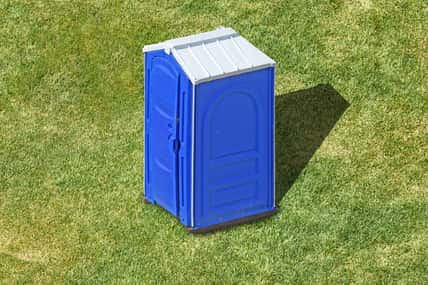 public portable plastic restroom cabin on green grass lawn aerial view of clean outdoor mobile toilet against nature background isolated bathroom lavatory exterior