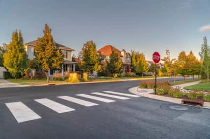 Pedestrian crossing on a street intersection day.