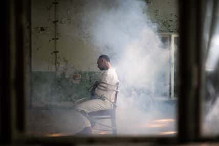 A crazy man in a straitjacket is
