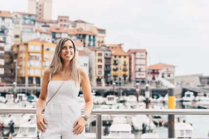 Young woman leaning against a railing, with