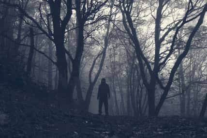 A hooded scary figure with glowing eyes.