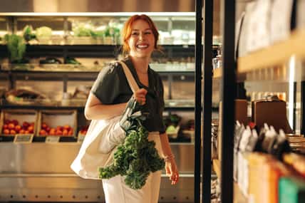 Female customer smiling cheerfully while carrying a