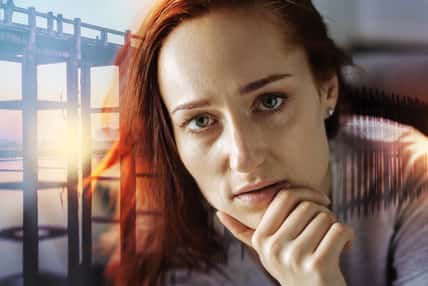 Attentive look. Calm young serious woman sitting