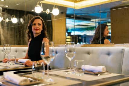 Beautiful young girl in luxury restaurant interior waiting