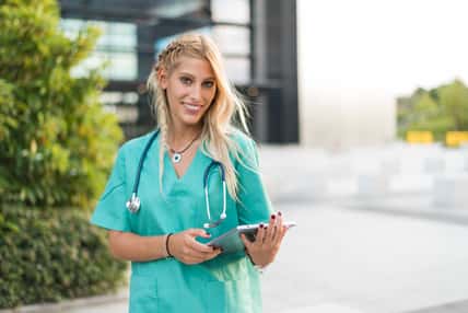 Female doctor, nurse or vet outdoors smiling looking at the camera isolated portrait closeup.