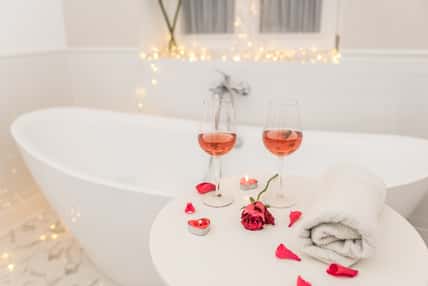 bathtub surrounded with candles, romantic atmosphere