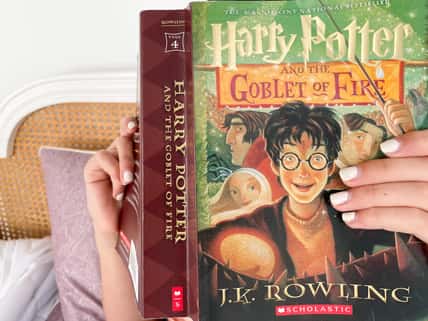 reading Harry Potter novel by J.K. Rowling