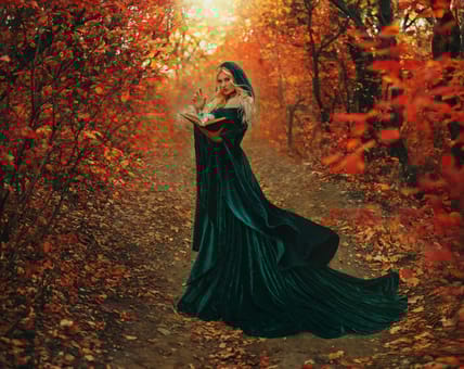 Fantasy woman witch hand casting spell creating magic with book