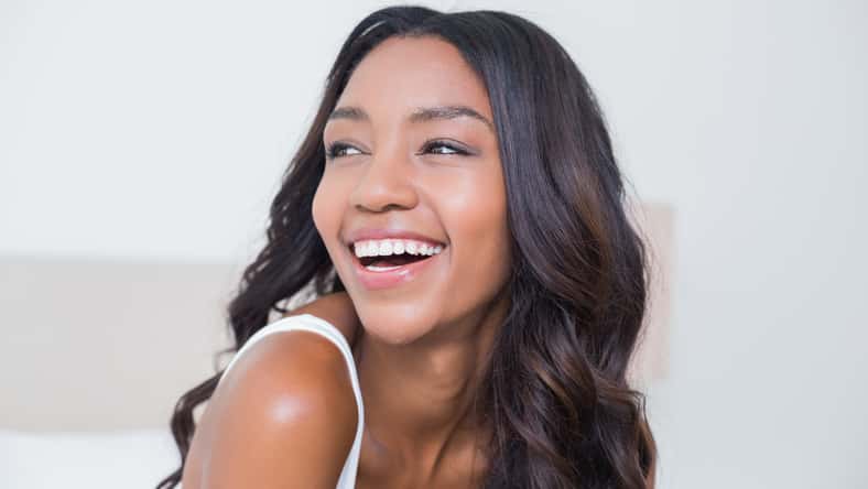 Beautiful woman smiling on bed