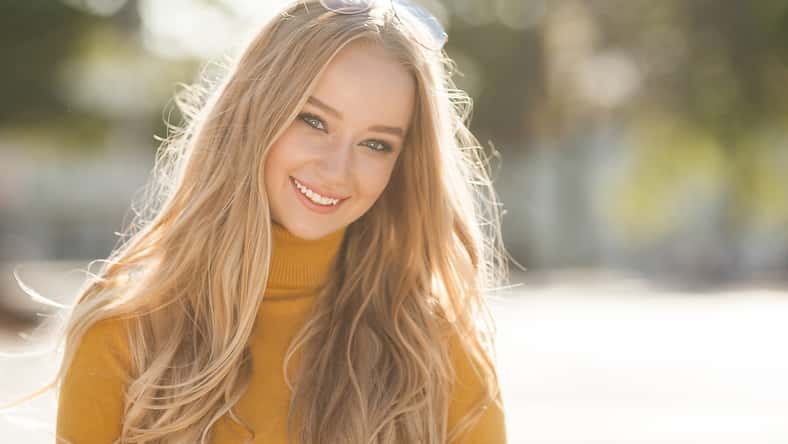 Closeup portrait of young beautiful woman. Female outdoors.