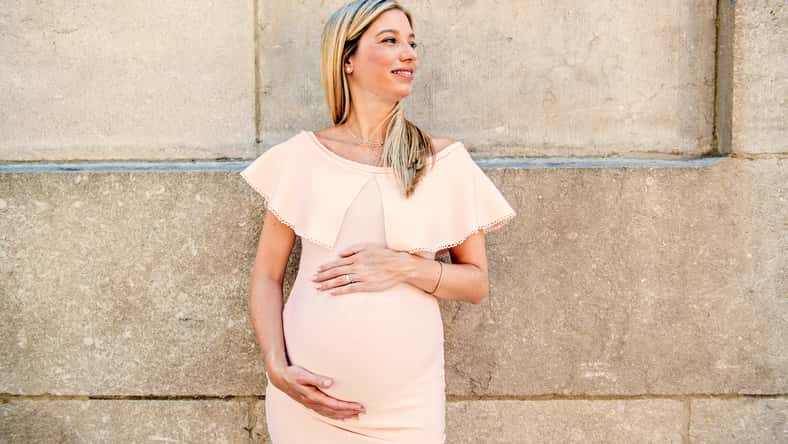 A Portrait of a pregnant woman in city street