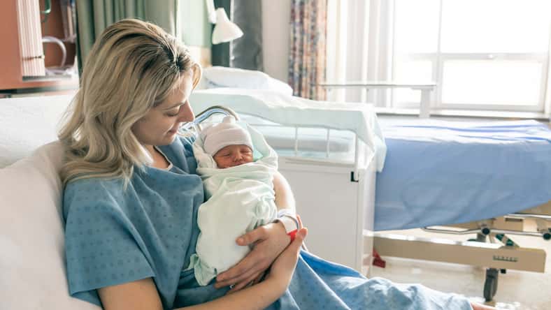 A Mother with her newborn baby at the hospital a day after a natural birth labor