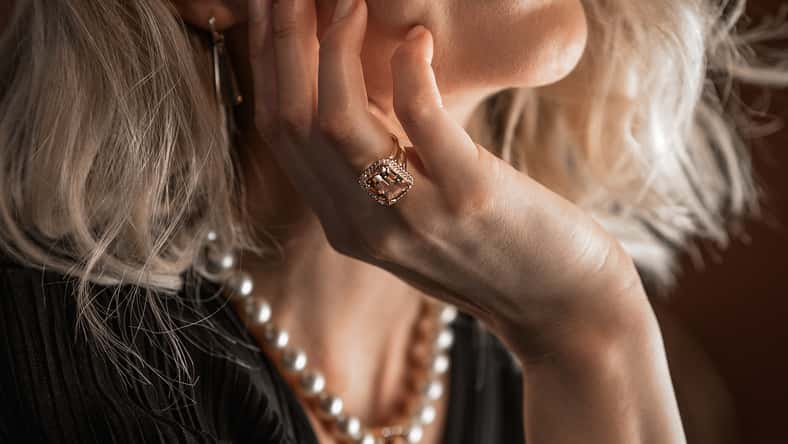 Romantic portrait of a girl dressed in an elegant dress and expensive jewelry