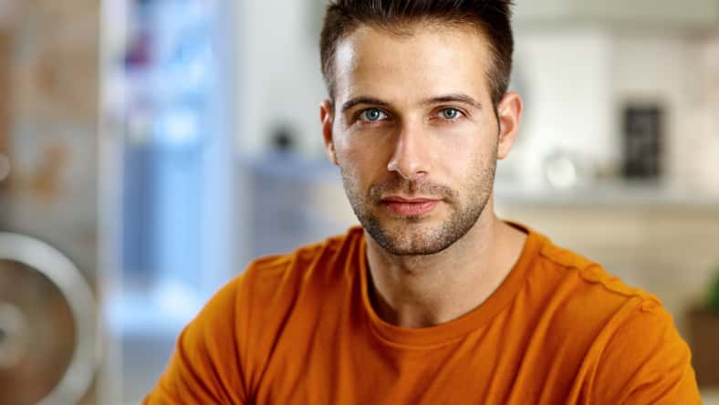 Closeup portrait of handsome young man, looking at camera.