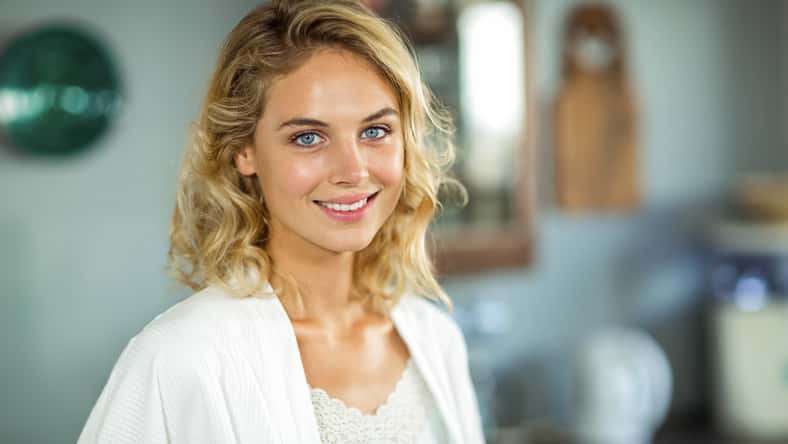 Beautiful young woman smiling at home