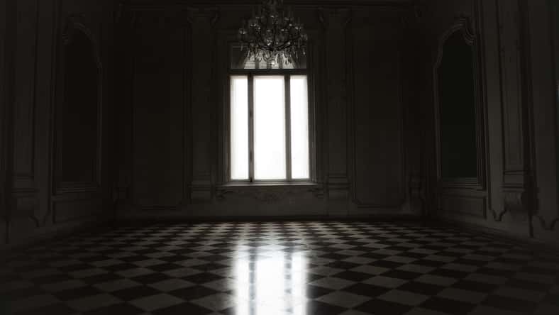 Window lit with mysterious white light in a spooky room built in baroque style.