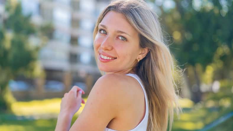 Young blonde woman at outdoors . Portrait