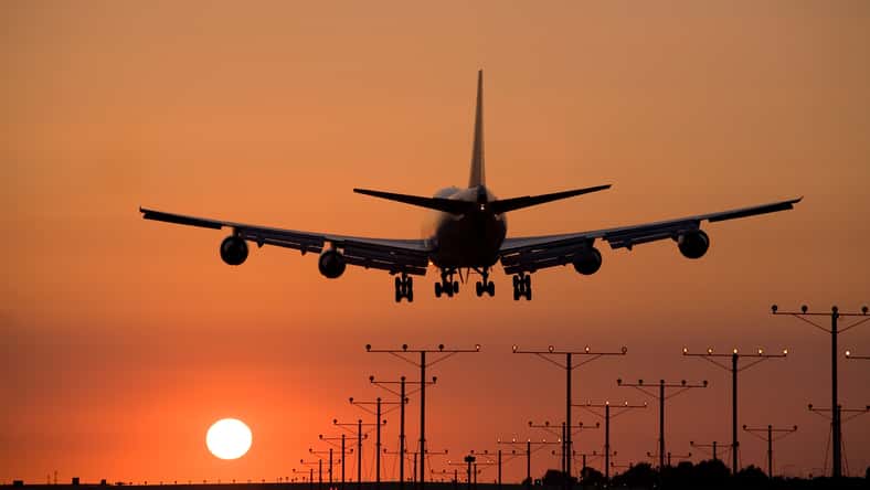 Jumbo jet coming in for a sunset landing