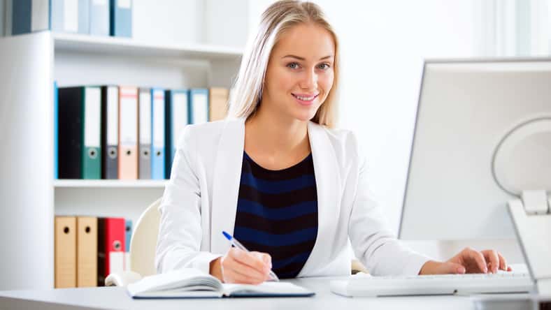 Portrait of a young business woman using computer at office