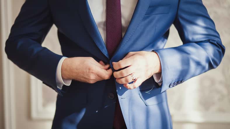 Man buttoning his jacket