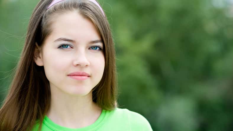 portrait of a young smiling beautiful european girl looking into camera